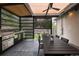 Covered outdoor kitchen features stainless steel grill, countertop, and large dining table at 1927 S Grant St, Denver, CO 80210