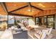 Inviting covered patio with wood ceiling, ceiling fan, hot tub, and stylish outdoor furniture creating an ideal relaxation space at 12186 W 34Th Pl, Wheat Ridge, CO 80033