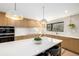 Modern kitchen with a large island, sleek cabinets, stainless steel appliances, and pendant lighting at 12186 W 34Th Pl, Wheat Ridge, CO 80033