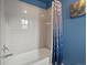 The bathroom features a tub with white tile surround and a nautical-themed shower curtain at 12061 Ivy Way, Brighton, CO 80602