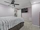 Bedroom showcasing a ceiling fan, a mounted TV, and access to a walk-in closet for added storage at 12061 Ivy Way, Brighton, CO 80602