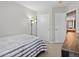 Neutral bedroom includes closet space and a colorful floor lamp for a playful touch at 12061 Ivy Way, Brighton, CO 80602