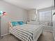 Bright bedroom with a white-framed bed and a window seat for cozy relaxation at 12061 Ivy Way, Brighton, CO 80602