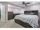 Cozy bedroom featuring a ceiling fan, plush carpet, and ample storage with dressers and a bed with drawers at 12061 Ivy Way, Brighton, CO 80602