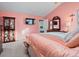 Inviting bedroom featuring warm colors, a large bed, TV, and a charming display cabinet at 12061 Ivy Way, Brighton, CO 80602