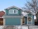 Two-story home boasts blue siding, a two-car garage, and a well-kept lawn for curb appeal at 12061 Ivy Way, Brighton, CO 80602