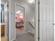 Hallway with open doorways to a bedroom and bathroom, creating a seamless flow at 12061 Ivy Way, Brighton, CO 80602