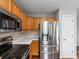 Kitchen with stainless steel appliances, light wood cabinets, and light countertops at 12061 Ivy Way, Brighton, CO 80602