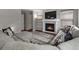 Living room featuring a large sectional sofa, a fireplace, and hardwood floors at 12061 Ivy Way, Brighton, CO 80602