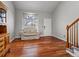 Cozy living room featuring hardwood floors, a comfortable sofa, and natural light from the window at 12061 Ivy Way, Brighton, CO 80602