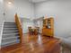 Open-concept living room features hardwood floors, high ceilings, and staircase to upper level at 12061 Ivy Way, Brighton, CO 80602