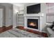 Bright living room featuring a fireplace, a built-in bookcase, and hardwood floors at 12061 Ivy Way, Brighton, CO 80602