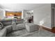 Living room featuring a sectional sofa, hardwood floors and an open layout to the kitchen at 12061 Ivy Way, Brighton, CO 80602