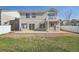 View of the backyard of a two-story home with a concrete patio and small balcony at 21642 E 55Th Ave, Denver, CO 80249