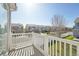 Balcony with white railing overlooking a neighborhood street with well-maintained homes at 21642 E 55Th Ave, Denver, CO 80249