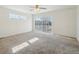 Spacious bedroom with neutral carpet, ceiling fan, and sliding glass doors to a balcony at 21642 E 55Th Ave, Denver, CO 80249