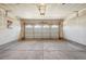 Spacious garage with ample room for parking and storage, illuminated by a central light fixture at 21642 E 55Th Ave, Denver, CO 80249