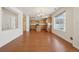 Open kitchen with wood cabinets, center island, and hardwood flooring at 21642 E 55Th Ave, Denver, CO 80249