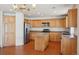 Traditional kitchen includes a center island, wood cabinets, and stainless steel appliances at 21642 E 55Th Ave, Denver, CO 80249