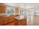 Inviting kitchen featuring wood cabinets, island, and stainless steel appliances at 21642 E 55Th Ave, Denver, CO 80249