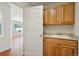 Small kitchenette including light wood cabinets, counter top, and sink at 21642 E 55Th Ave, Denver, CO 80249