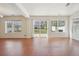 Bright living room features wood floors, and glass patio doors leading to the backyard at 21642 E 55Th Ave, Denver, CO 80249