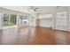 Open living room offers ample natural light, wood floor, and ceiling fan at 21642 E 55Th Ave, Denver, CO 80249