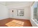 Bright living room featuring wood floors, large windows, and a front door with a window panel at 21642 E 55Th Ave, Denver, CO 80249