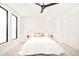 Bright bedroom with plush bed and large windows at 3433 Lawrence St # 1, Denver, CO 80205