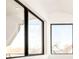 Bright bedroom featuring large windows with black frames at 3433 Lawrence St # 1, Denver, CO 80205