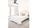 Bright bedroom with plush bed and large windows at 3433 Lawrence St # 1, Denver, CO 80205
