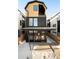 Modern two-story home with a sleek, black and yellow exterior, and a small patio at 3433 Lawrence St # 1, Denver, CO 80205