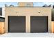 Two-car garage with dark brown doors and stucco exterior at 3433 Lawrence St # 1, Denver, CO 80205