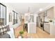 Modern kitchen with light wood cabinets and a large island at 3433 Lawrence St # 1, Denver, CO 80205