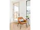 Light and airy living room with a comfortable leather chair and door leading to backyard at 3433 Lawrence St # 1, Denver, CO 80205