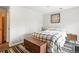 Bright bedroom with stylish plaid blanket, wood flooring, and wood bedside table at 7221 S Brook Forest Rd, Evergreen, CO 80439