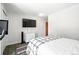 Bedroom with stylish plaid blanket, wood flooring, and a wall-mounted television at 7221 S Brook Forest Rd, Evergreen, CO 80439