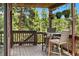 Relaxing covered deck with seating area, offering a serene escape amidst the lush greenery at 7221 S Brook Forest Rd, Evergreen, CO 80439