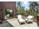 Outdoor deck features comfortable seating area with scenic wooded views at 7221 S Brook Forest Rd, Evergreen, CO 80439