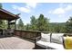 Outdoor deck with comfortable seating and railing with views of the green trees at 7221 S Brook Forest Rd, Evergreen, CO 80439