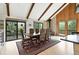 Dining area with wood floors, fireplace, deck access and great natural light at 7221 S Brook Forest Rd, Evergreen, CO 80439