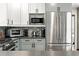 Modern kitchen boasts stainless steel appliances, stylish cabinets, and mosaic backsplash at 7221 S Brook Forest Rd, Evergreen, CO 80439