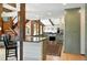 Open concept kitchen with wooden accents, hardwood floors and bar seating leading to the living room at 7221 S Brook Forest Rd, Evergreen, CO 80439