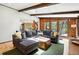 Cozy living room featuring wood accents, beamed ceilings, and an open floor plan connecting to the kitchen at 7221 S Brook Forest Rd, Evergreen, CO 80439