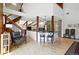 Open-concept living area with modern finishes, wood beams, and a staircase leading to a loft at 7221 S Brook Forest Rd, Evergreen, CO 80439