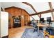 Office space featuring vaulted ceiling, wood beams, ample lighting, and a wooden bookshelf at 7221 S Brook Forest Rd, Evergreen, CO 80439