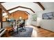 Office space featuring vaulted ceiling, wood beams, ample lighting, and hardwood floors at 7221 S Brook Forest Rd, Evergreen, CO 80439