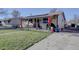 House exterior showcasing a well-maintained lawn and driveway at 6651 Albion St, Commerce City, CO 80022