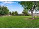 Large backyard with grassy area, playground, and mature trees at 10399 Zenobia Ct, Westminster, CO 80031