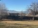 Backyard view with mountain backdrop and trampoline at 10399 Zenobia Ct, Westminster, CO 80031